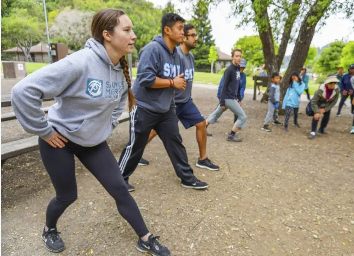 students practicing leg stretches