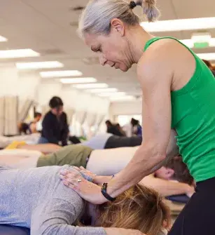 Physical therapy student practicing a technique on another student