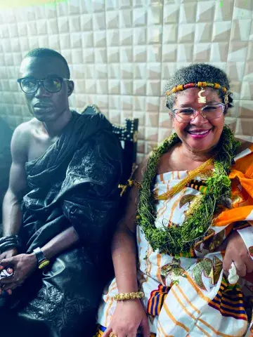 Carmen Ward-Sullivan and King Katakyie Agyemang Duah III dressed in traditional African clothing.