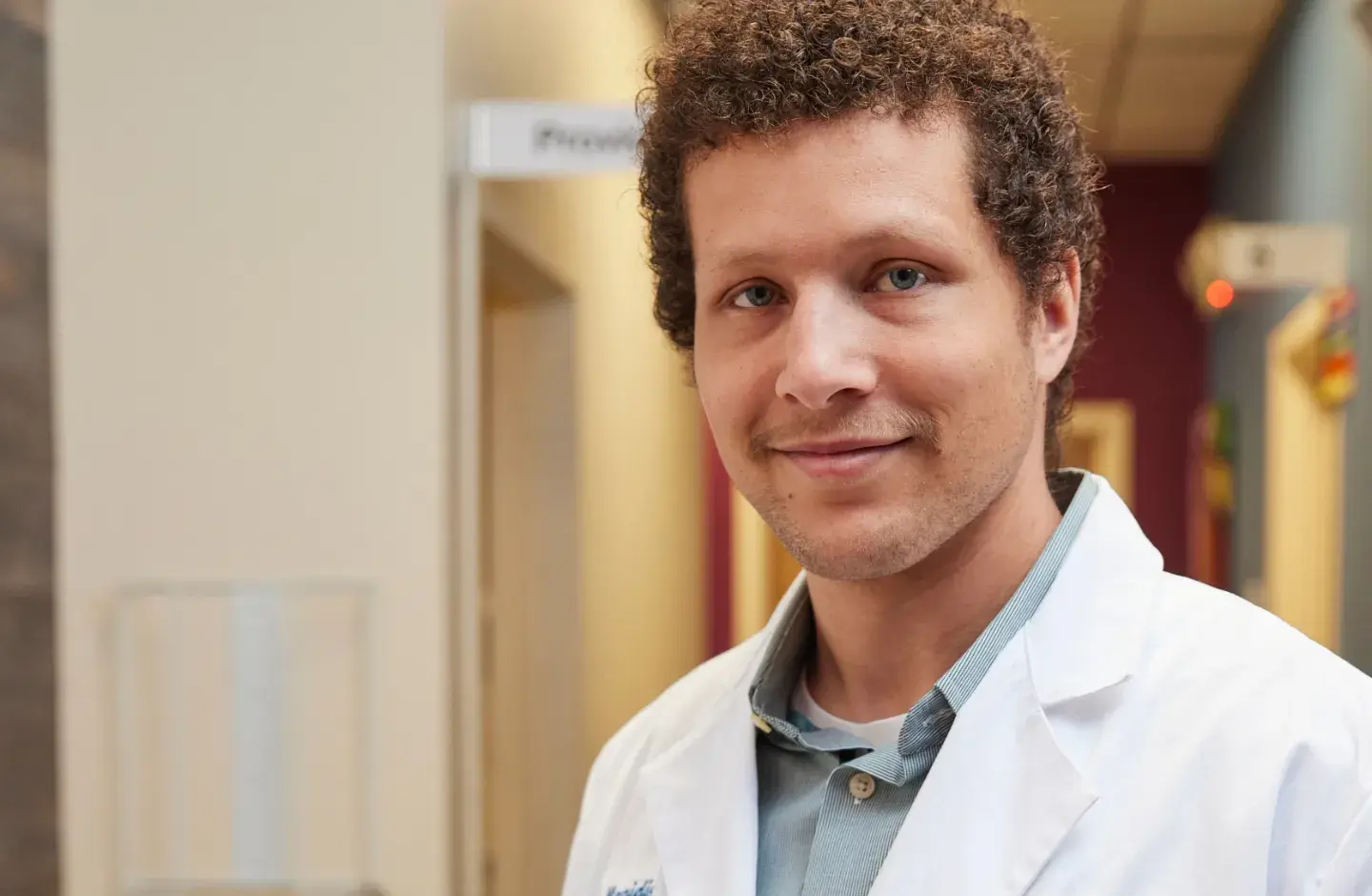 Male nurse in clinic smiling
