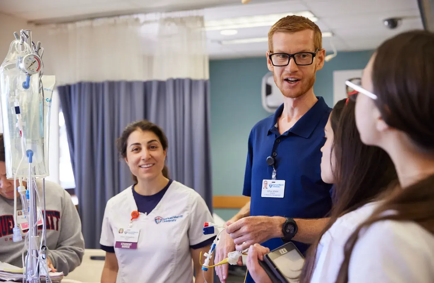 Instructor talking to students in simulation lab