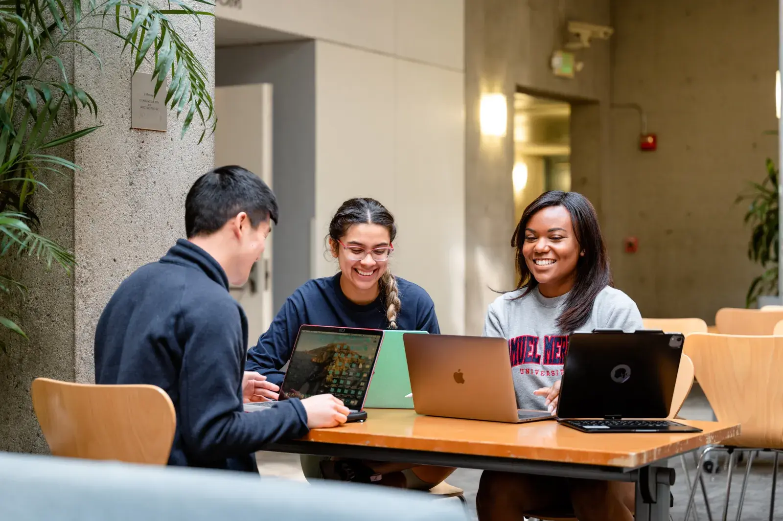 Three students studying at table